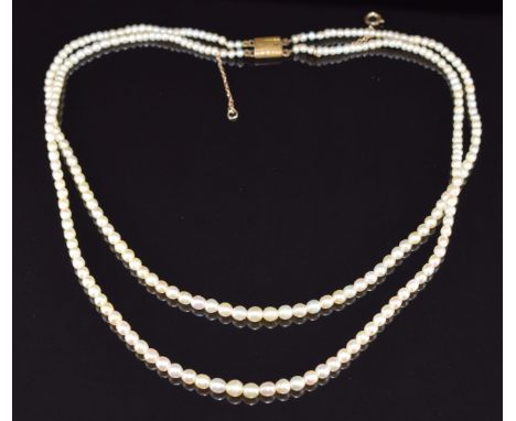 A double strand of natural pearls, largest pearl 4.4mm and smallest 2.6mm, with Gem &amp; Pearl Lab certificate, 16.4g