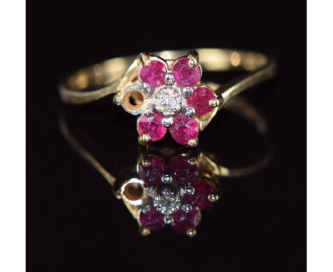 A 9ct gold ring set with a diamond and rubies in a cluster, 1.7g, size M