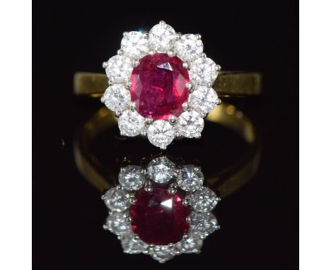 An 18ct gold ring set with a 1ct cushion cut ruby surrounded by ten round brilliant cut diamonds, each approximately 0.1ct, 4