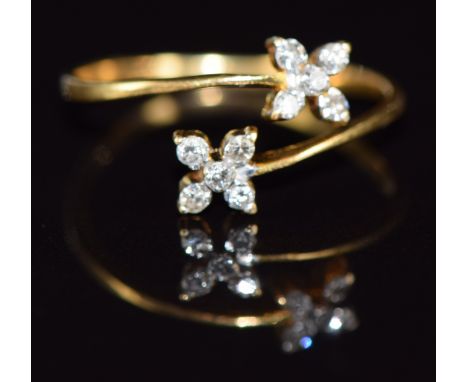 An 18ct gold ring set with diamonds in two flower clusters, 1.5g, size M