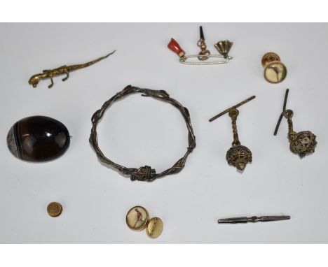A silver bangle, agate brooch, coral charm etc