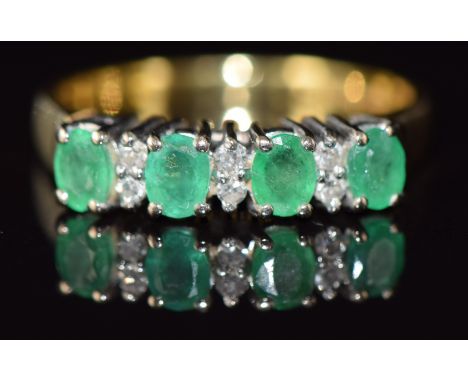 An 18ct gold ring set with alternating emeralds and diamonds, 3.4g, size M