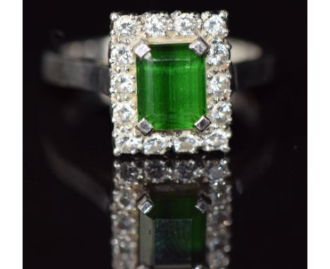 An 18ct white gold ring set with an emerald cut tourmaline surrounded by diamonds, 5.6g, size N