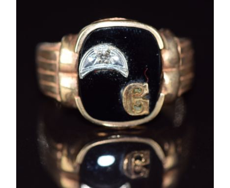 A 10k gold signet ring set with onyx and a diamond, 5.9g, size T