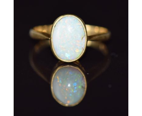 An 18ct gold ring set with an opal cabochon cabochon, 2.7g, size K