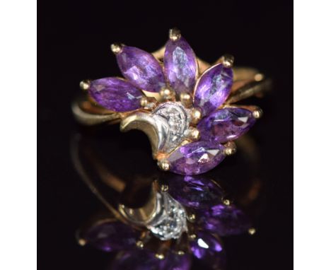 A 9ct gold ring set with a diamonds and marquise cut amethysts, 3.2g, size J/K