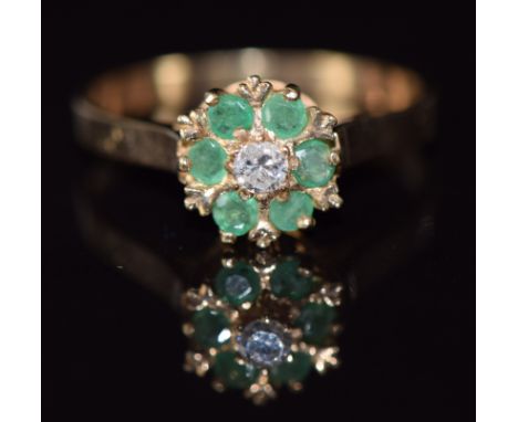 A 9ct gold ring set with a diamond and emeralds, 2.5g, size P