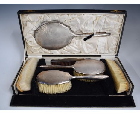 Cased Art Deco hallmarked silver dressing table set, comprising hand mirror, four brushes and comb, Birmingham 1931, maker&nb