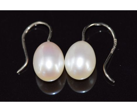 A pair of 18ct white gold earrings set with a pearl to each, the pearls approximately 1.2cm