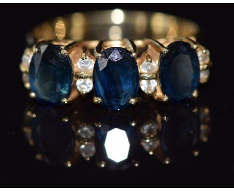 A 14ct gold ring set with sapphires and cubic zirconia, 4.4g, size O