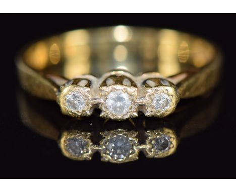 An 18ct gold ring set with three diamonds, 3.2g, size N