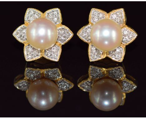 A pair of 18ct gold earrings set with a pearl surrounded by diamonds in a floral setting, 5.3g