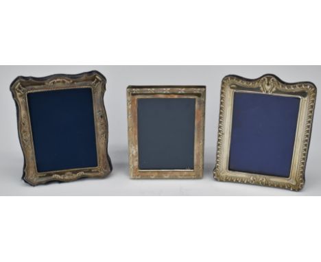 Three hallmarked silver photograph frames, all to suit 6 x 4 inch photo and with easel backs, Chester 1904, Sheffield 1992 an