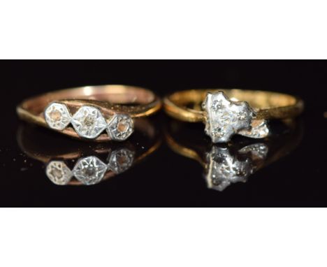 An 18ct gold ring set with diamonds in a clover shaped platinum setting (2.5g, size K) and a 9ct gold ring set with three dia