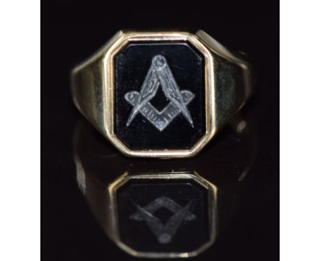 A 9ct gold ring set with onyx with carved Masonic symbol, 5.6g, size N