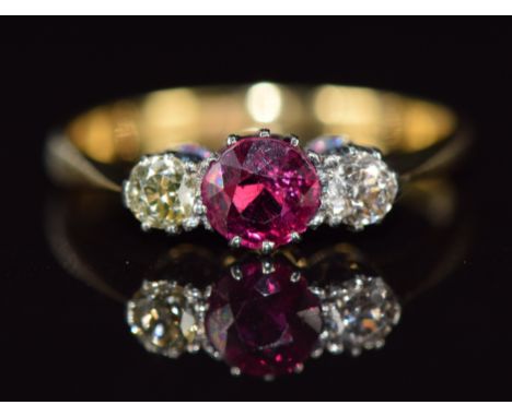 A c1920 18ct gold ring set with a ruby of approximately 0.4ct and diamonds in a platinum setting, 2.3g, size M