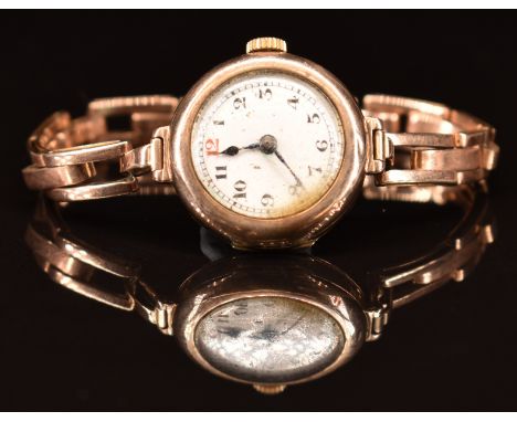 Unnamed 9ct gold ladies wristwatch with blued hands, black Arabic numerals and white enamel dial, on 9ct gold expanding brace