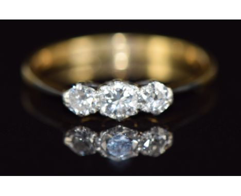 An 18ct gold ring set with three diamonds, 2.3g, size R