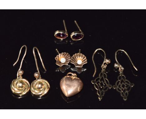 Four pairs of earrings including one pair set with garnets and another in the form of a shell set with a seed pearl to each a