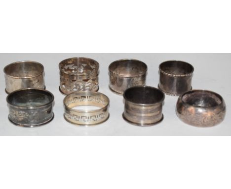 Eight silver napkin rings comprising seven various hallmarked examples and a Chinese example, weight 110g