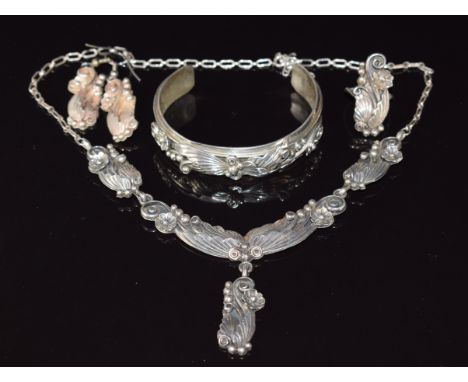 A suite of silver Navajo jewellery comprising bangle, necklace, ring and earrings