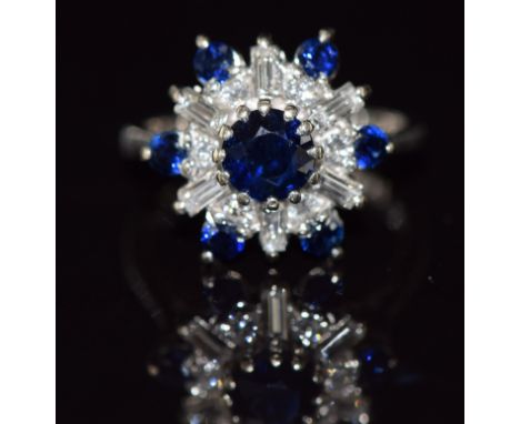 An 18ct white gold ring set with round cut sapphires and round and baguette cut diamonds, 5.2g, size K