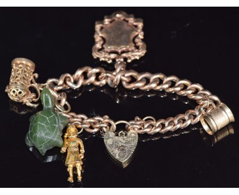 A 9ct rose gold curb link charm bracelet with gold plated charm, two 9ct gold charms, jade turtle, etc, 18cm long