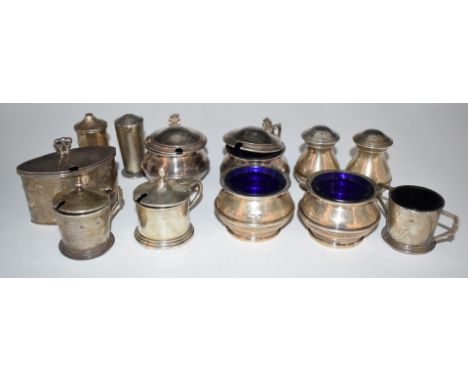 Twelve various hallmarked silver salts, mustards and peppers, most with blue glass liners, including Art Deco engine turned e