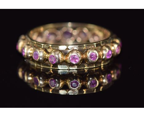 A 9ct&nbsp;gold eternity ring set with pink sapphires, 3.7g, size O/P