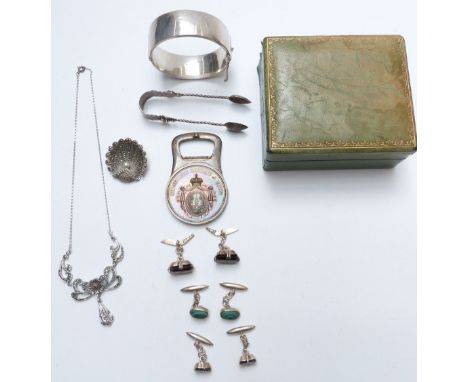 A collection of&nbsp;silver&nbsp;jewellery including bangle, tongs, bottle opener, marcasite brooch and three pairs of cuffli