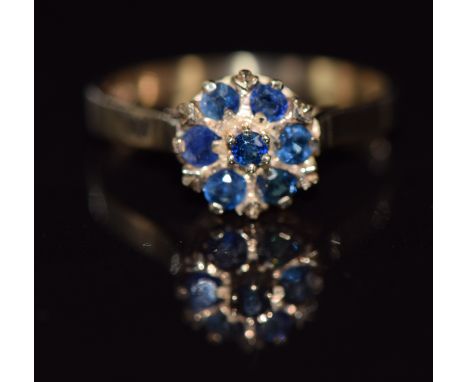 A 9ct gold ring set with sapphires in a cluster, 2.6g, size N