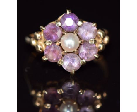 A 9ct gold ring set with a pearl surrounded by amethysts, 3.5g, size M