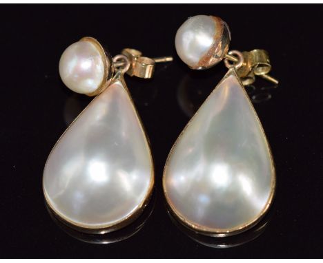 A pair of 9ct gold earrings set with a pearl and a pear shaped pearl cabochon to each, 7.6g, 3cm