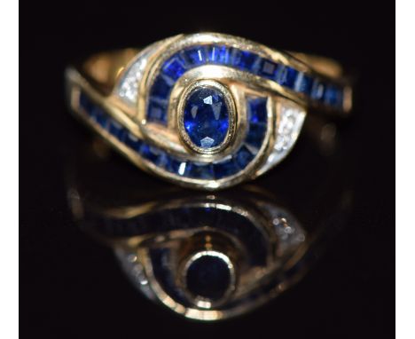 A 14k gold ring set with sapphires and diamonds in a twist setting, 3.4g, size M