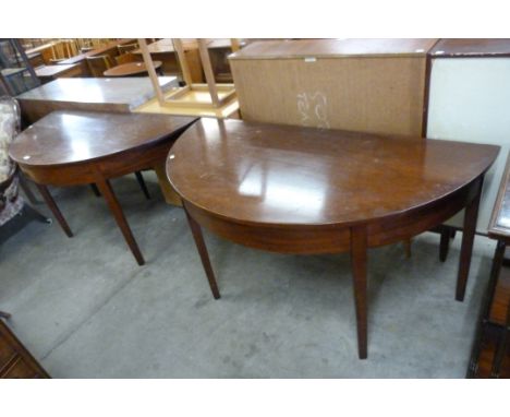A pair of George IV mahogany demi-lune console tables 