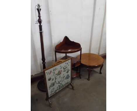 A hardwood corner whatnot, a circular oak coffee table, mahogany standard lamp and an embroidered firescreen 