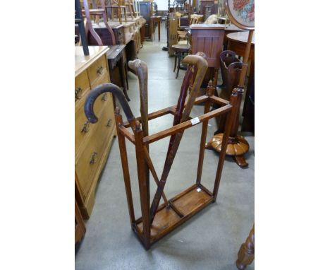 An oak stick stand and four walking canes 