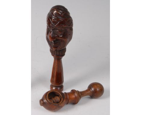 A 19th century yew wood novelty Mr Punch nut cracker, having a carved head and turned screw handle, 16cm, together with one o