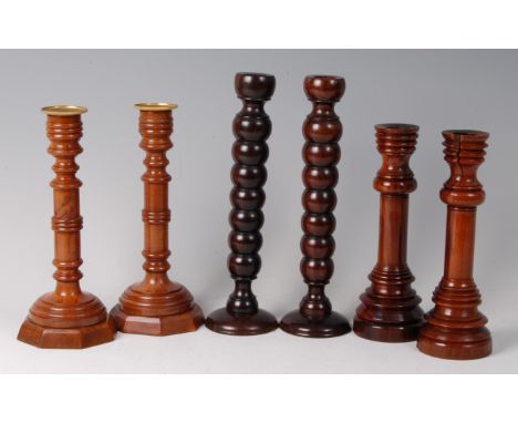 A pair of early 20th century turned yew wood table candlesticks, bearing label verso 'The Wordsworth Yews made by Richard Wil