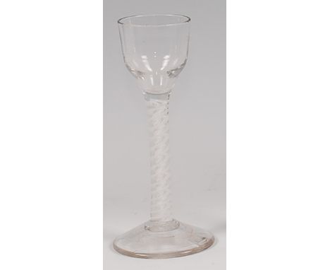 A mid-18th century pedestal cordial glass, having a round funnel bowl and double opaque twist stem to a conical foot, h.14cm 