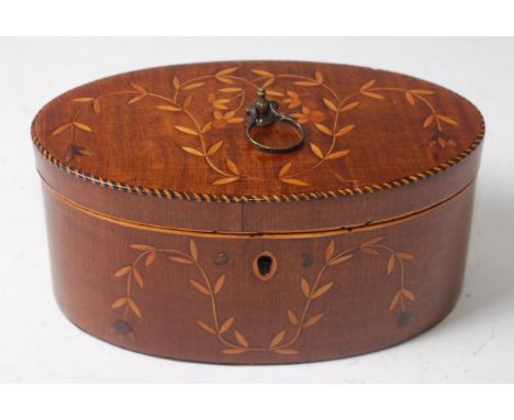 A George III mahogany, satinwood and chequer strung tea caddy of oval form, the hinged lid with brass ring handle revealing a