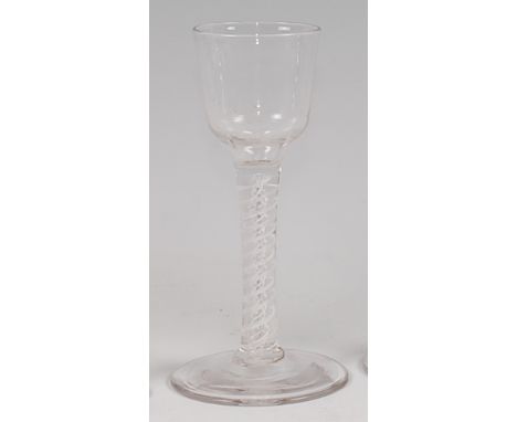 A mid-18th century pedestal cordial glass, having a round funnel bowl and double opaque twist stem to a conical foot, h.14cm 