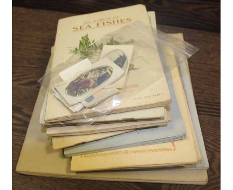 TEN ALBUMS OF CIGARETTE CARDS
including motor cars, sea fishes, wild flowers, etc, along with a small selection of loose ciga