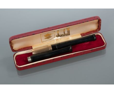ALFRED DUNHILL CIGARETTE HOLDER
with 9 carat gold ferrule and spare holder, in a original case, 9.5cm long