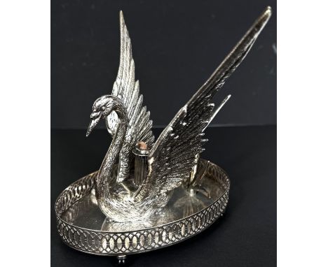 A silver plated swan shaped bandy warmer with central light. 