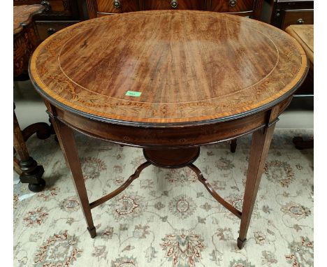 A 19th century circular inlaid table with berry, leaf and swag border with square tapering legs, smaller plant shelf below, d