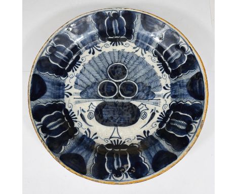 An early 18th century Dutch Delft pottery dish with central panel of Peacock vase and geometric border, yellow rim bearing 3 