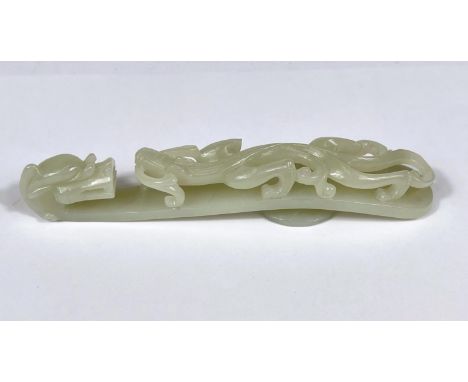 A large Chinese jade coloured hardstone belt buckle with dragon decoration length 13cm 