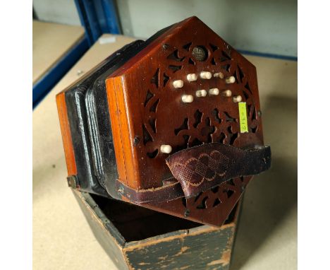 A 19th century concertina by Lachenal, 10 buttons to each end, with fretwork back and front, original label (some buttons stu