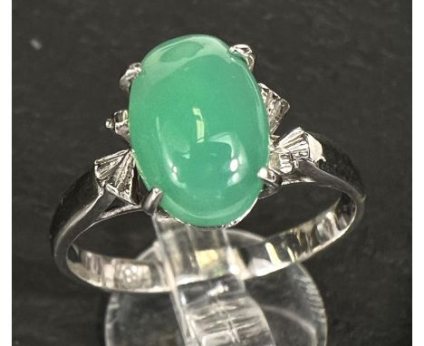 A dress ring set pale green jade cabochon, white metal shank stamped '18k', 2.8gm 